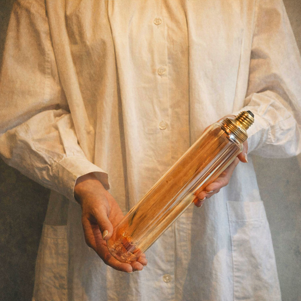 Ampoule tubulaire T60 LED 1800 K – lumière orangée ambrée et effet filament carbone ultra‑fin.